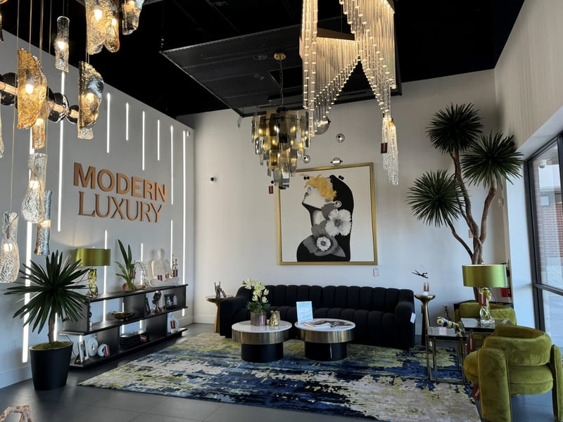 Modern Luxury showroom entrance with sculptural yucca and gallery-wall chandeliers
