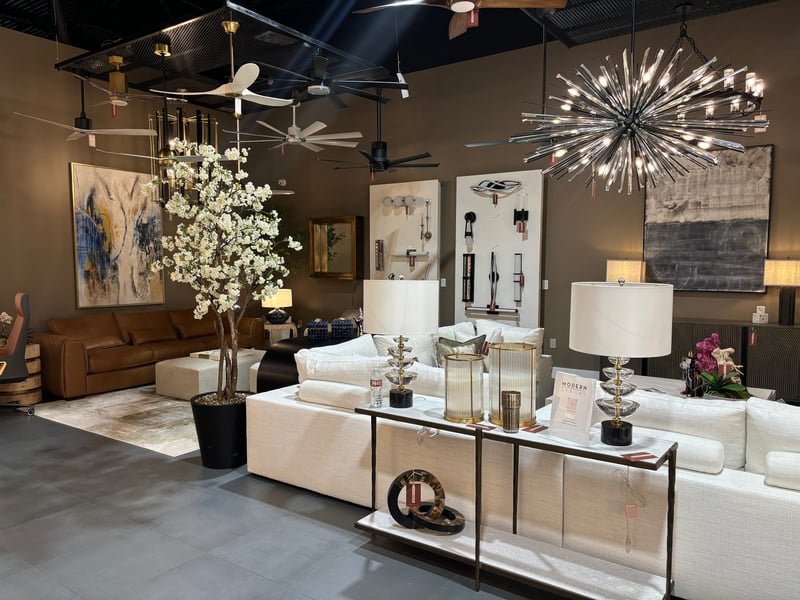 Flowering tree styled in the Modern Luxury showroom under a sculptural chandelier